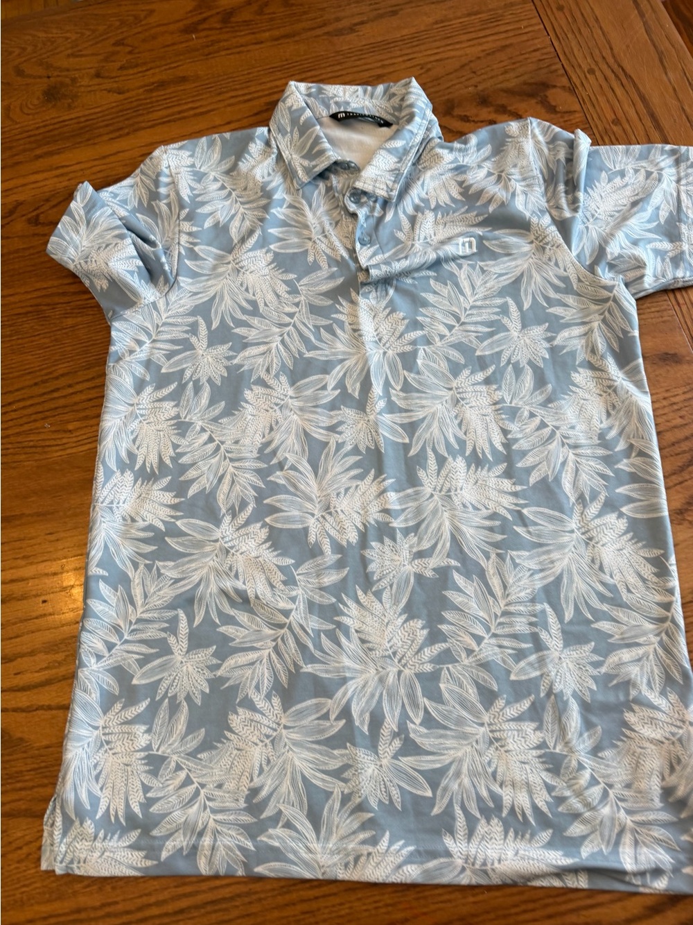 TravisMathew Light Blue Polo with White Tropical Leaf Print